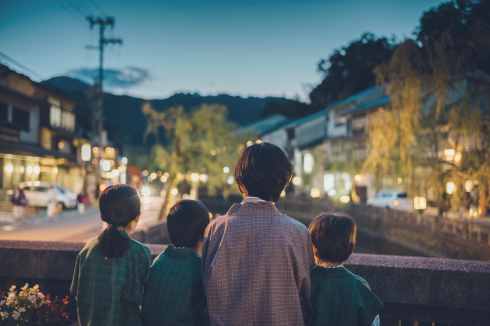 写真：夜の美しい城崎温泉を眺める女性1人と子供3人